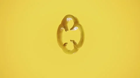 Close-Up View of Single Jalape o Slice on Yellow Background Stock Footage 306366674