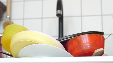 Close up view of a sink full of dirty dishes, cluttered home kitchen Stock Footage 291670457