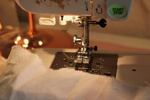 Close-Up View of Skilled Hands Operating a Modern Sewing Machine Stock Photos