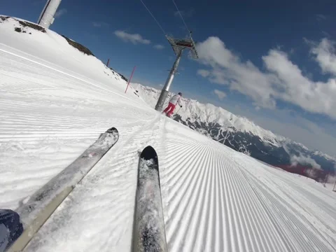 Close-up view of the skis sliding with great speed on the slope down wasted snow Stock Footage 163247276