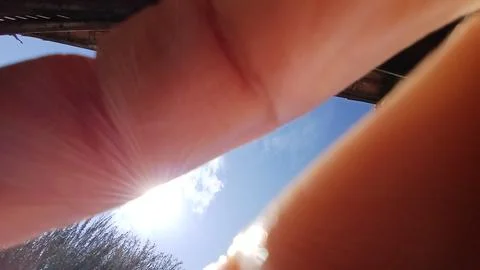 Close-Up View of Sky with Finger Obstruction 스톡 사진