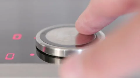 A close-up view of a sleek induction cooktop with illuminated controls ready for Stock Footage 281598841