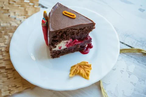 Close view of slice of chocolate cake decorated for back to school theme Stock Photos