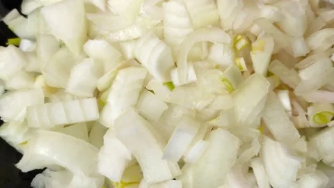 Close-up view sliced onion rotates in a black plate. Stock Footage 199935960
