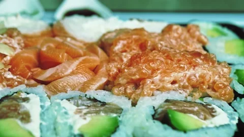Close up view on sliced sushi rolls with vegetables and salmon, healthy tasty Stock Footage 152728286