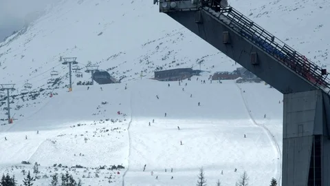 Close-up view of slope on the skiing resort. Skiers enjoying snowy slopes in hig Stock-Footage 88352445