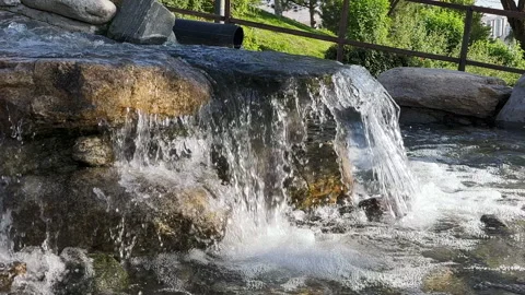 Close-up view of a small artificial stone waterfall Stock Footage 256158379