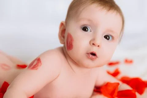 A close view, a small child with almost no hair, looks with a surprised look Stock Photos