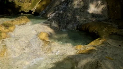 Close-up view of a small flowing limestone waterfall Stock Footage 321321536