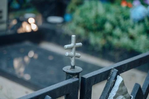Close-up view of a small four-pointed metal cross decoration atop a decorat.. Stock Photos