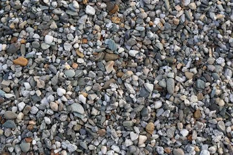 Close-up view of small gray and brown pebbles on ground Stock Photos