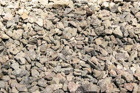 A close-up view of small, grey rocks on a sunny day Stock Photos