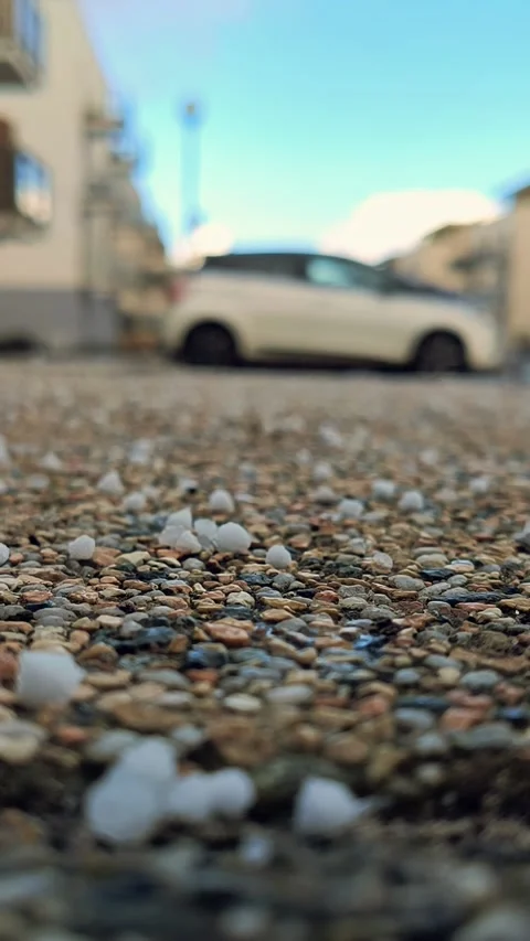 Close-Up View Of Small Hailstones On Pebbled Ground With Stock Footage 307965607