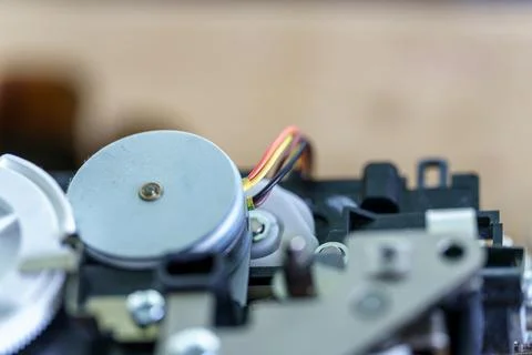 Close-up view of a small motor inside a mechanical device, showcasing wires.. Stock Photos