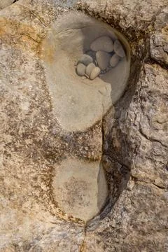 Close-up view of small pebbles gathered in a natural rock hollow on a Cyprus  Stock Photos