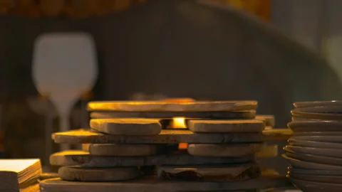 Close up view of small stacked boards with a blurry fire oven as background Stock Footage 142633112