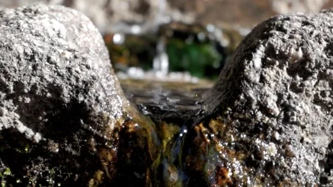 A close-up view of a small waterfall in the snowy landscape of Valle de la Stock Footage 293713645