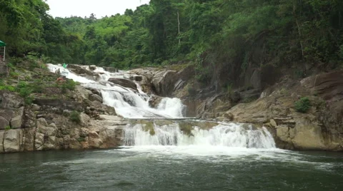 Close-up view of small waterfall in a tropical jungle. Water is falling down to Stock Footage 67485367