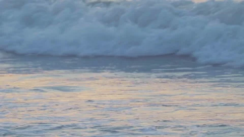 Close-up view of small waves on the sea in the morning or evening reflecting the Stock Footage 277432680