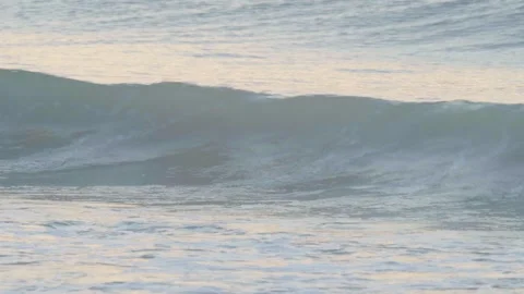 Close-up view of small waves on the sea in the morning or evening reflecting the Stock Footage 277432682