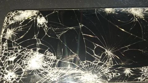 Close up view of a smartphone screen with shattered glass surface Foto stock