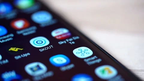 Close up view of the smartphone screen with the Skout app icon jumping. Stock Footage 117850895