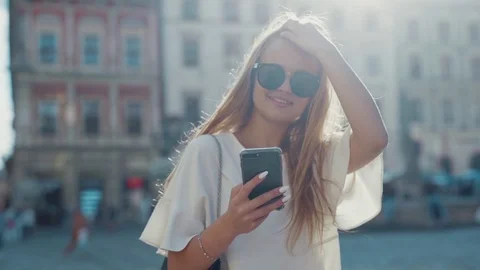 Close up view of smiling charming blonde woman confidently walking down the city Stock Footage 112673678