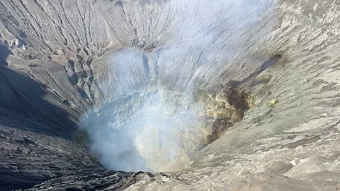 Close view of smoking Bromo volcano crater at sunrise on Java island, Indonesia. Video stock 332756697