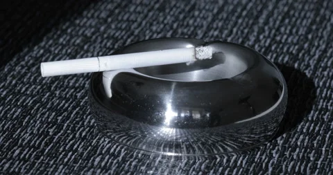 Close up view of Smoldering Cigarette in Ashtray Stock Footage 128894715