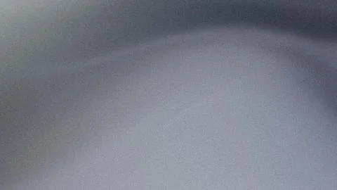 A close up view of a smooth grey metallic surface with a subtle gradient an.. Illustrazione stock