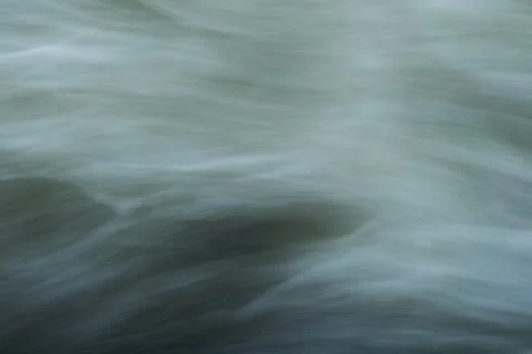 A close up view of a smooth river current captured using a long-exposure te.. 写真素材