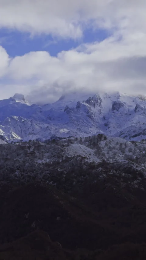 Close view of snowy mountain peaks covered by moving clouds. Stock Footage 337652847
