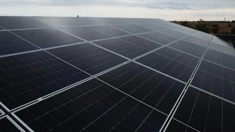 Close view of a solar panel array with bright sunlight reflection. Vídeo Stock 345610632