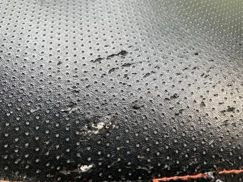 Close up view some damaged of the black patterned seat cover Stock Photos