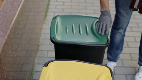 Close view of the sorting bin and the male hands in gloves puts two glass Stock Footage 203807566