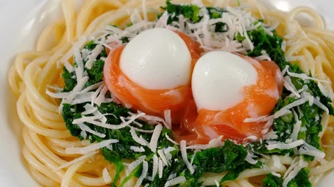 Close-up view of Spaghetti with salmon and quail eggs, green spinach sauce Stock Footage 87407771