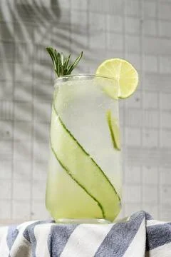 Close view of sparkling cucumber lime drink with rosemary in clear glass, Stock Photos