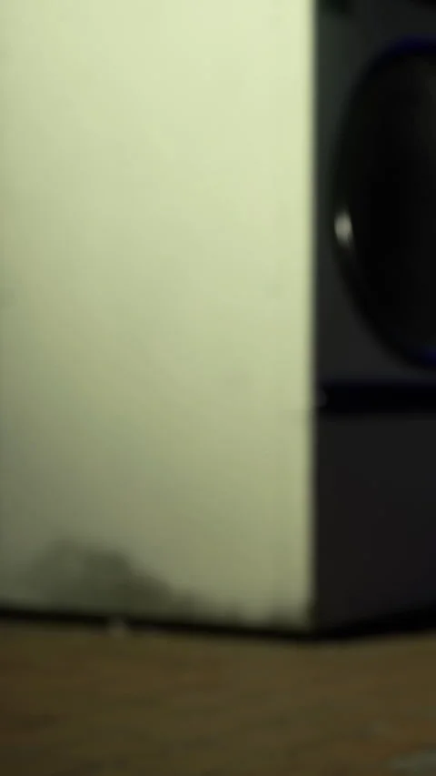 Close view of a speaker and wall in a room during an evening music session Stock Footage 331679172