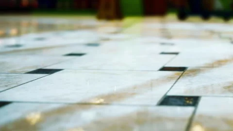 Close view of a speckled floor in a public space with light reflections Stock Footage 344967744