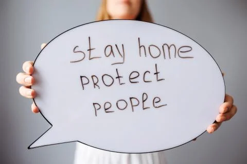 Close up view of the speech bubble with text stay home, protect people. Stock Photos