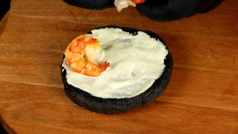 Close up view, Speed up time process of making a black seafood burger Stock Footage 75253570
