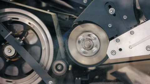Close-up view on spinnig detail of machine at printing house. Stock Footage 112214710