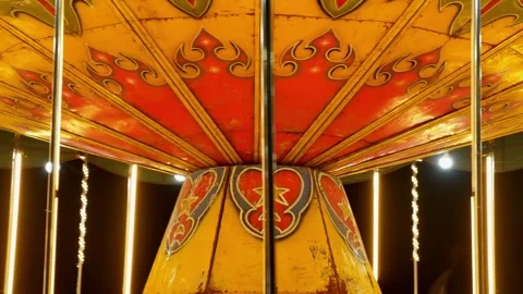 Close-up view of a spinning retro glowing carousel ride at an amusement park. Stock Footage 291848629