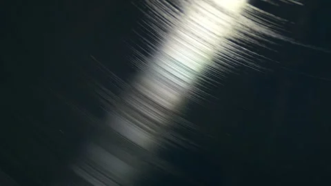 Close view of spinning vinyl record with reflections on surface Stock Footage 347155775