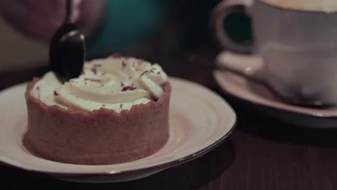 Close up view of spoon breaks off a piece of cake on plate. Stock Footage 153549584