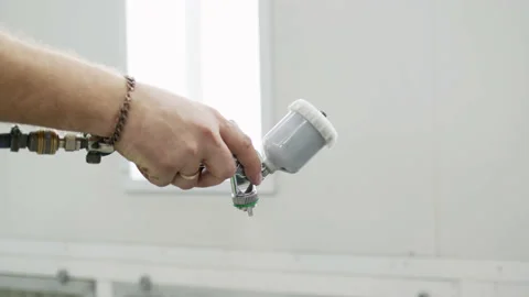 Close view of spray gun in hands of person painter, painting car or other thing Stock Footage 195167445