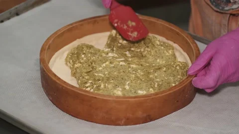 Close up view of spreading pie filling into baking dish with spatula Stock Footage 145567819