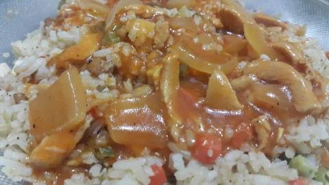 Close up view of spreading sauce on white fried rice Chinese dish with carrot Stock Photos