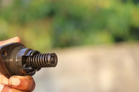 Close view of Spring and other parts of diesel fuel injector held in the hand Stock Photos