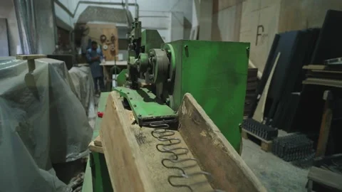 Close-up view of spring installation machine inside wood workshop with Stock Footage 307947873